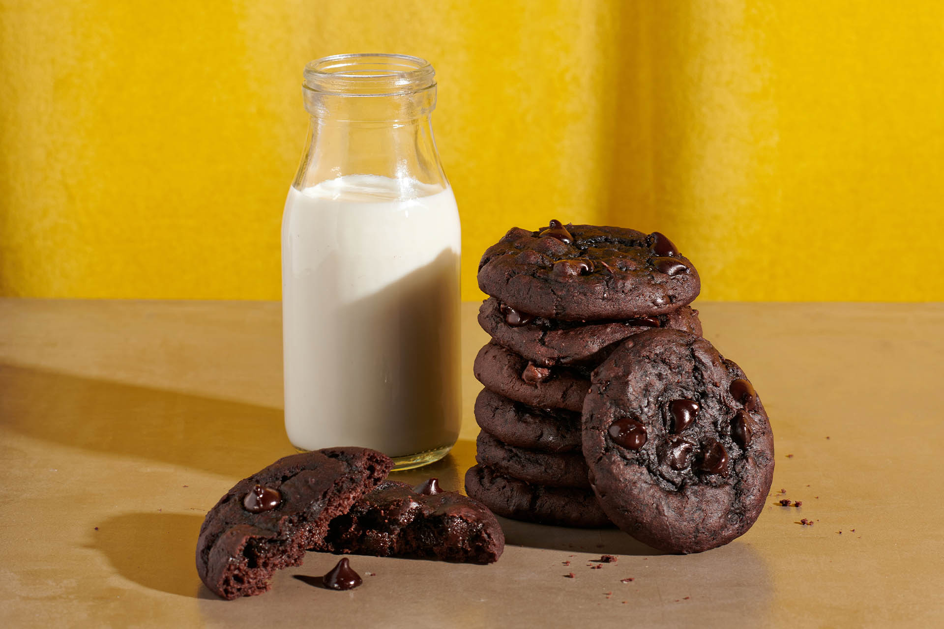 Stack of chocolate fudge and black bean cookies with a glass of milk.