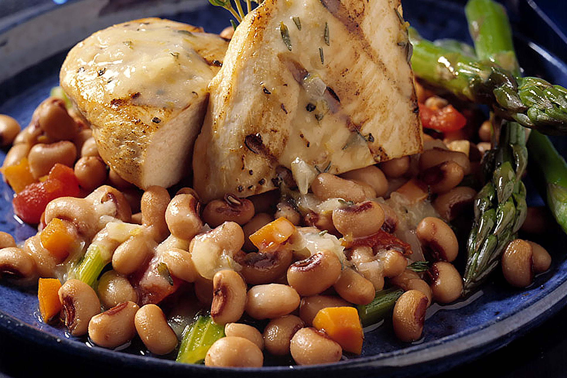 Grilled chicken breast served on a bed of blackeye peas and Navy beans