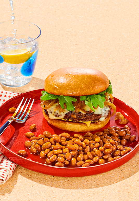Cheeseburger on a plate with baked beans