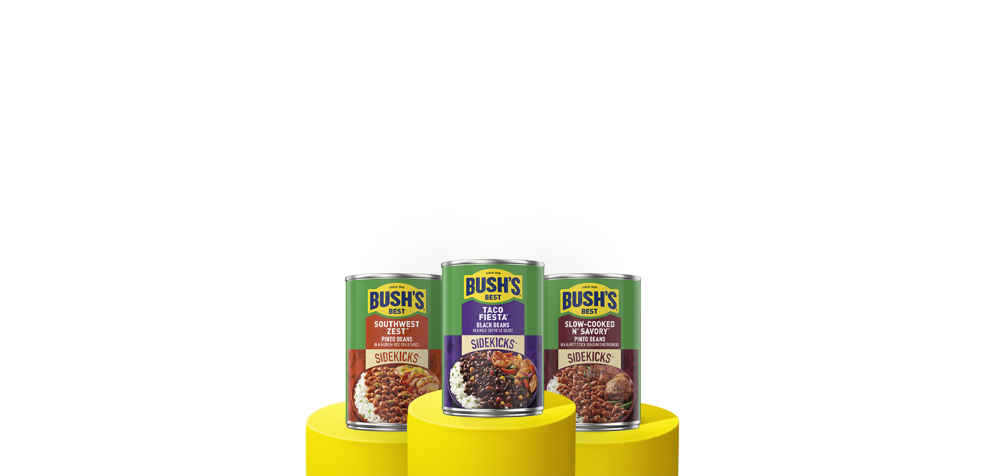 Three cans of Bush's Sidekicks beans on a yellow pedestals.