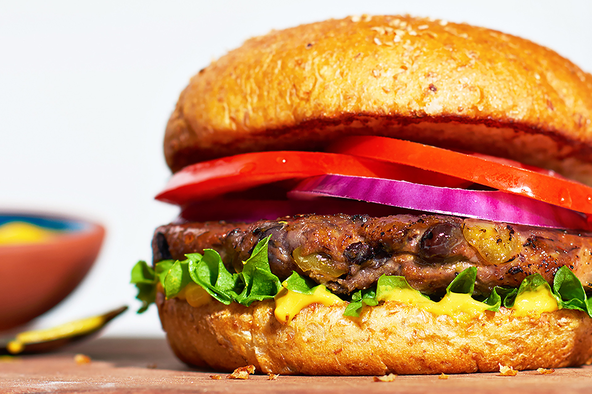 Black bean burger on bun with lettuce, tomato and onion