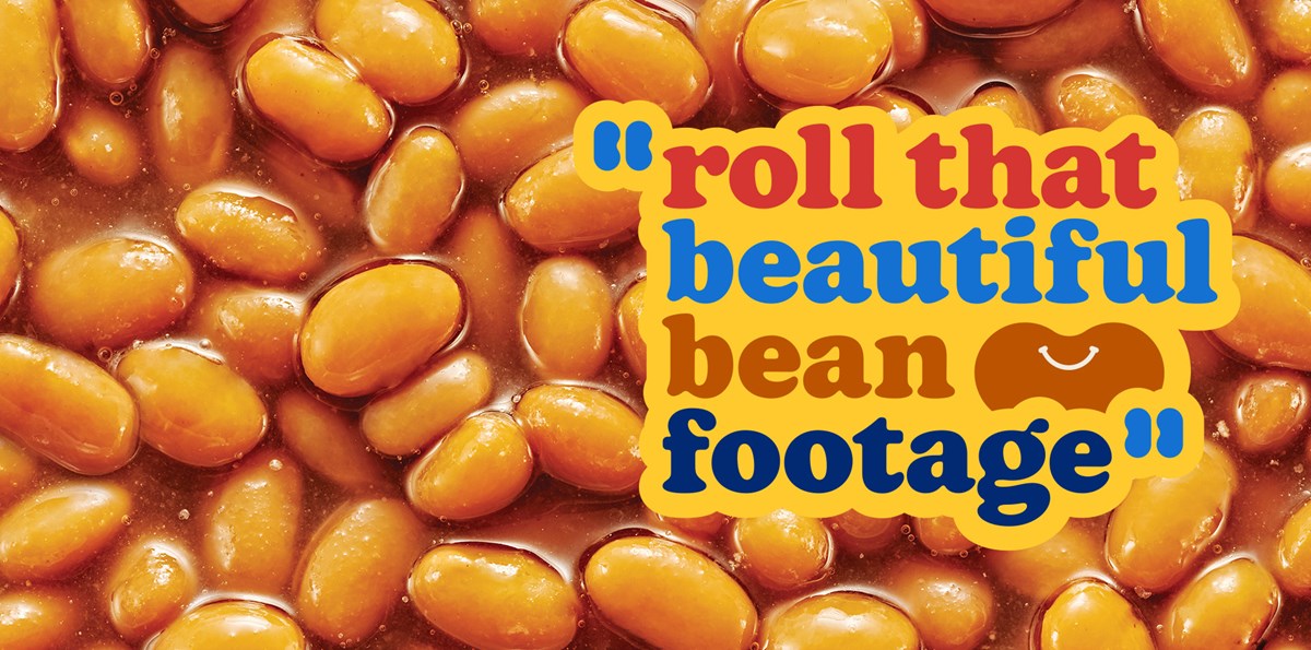 A close-up image of baked beans, with the text "roll that beautiful bean footage" overlaid