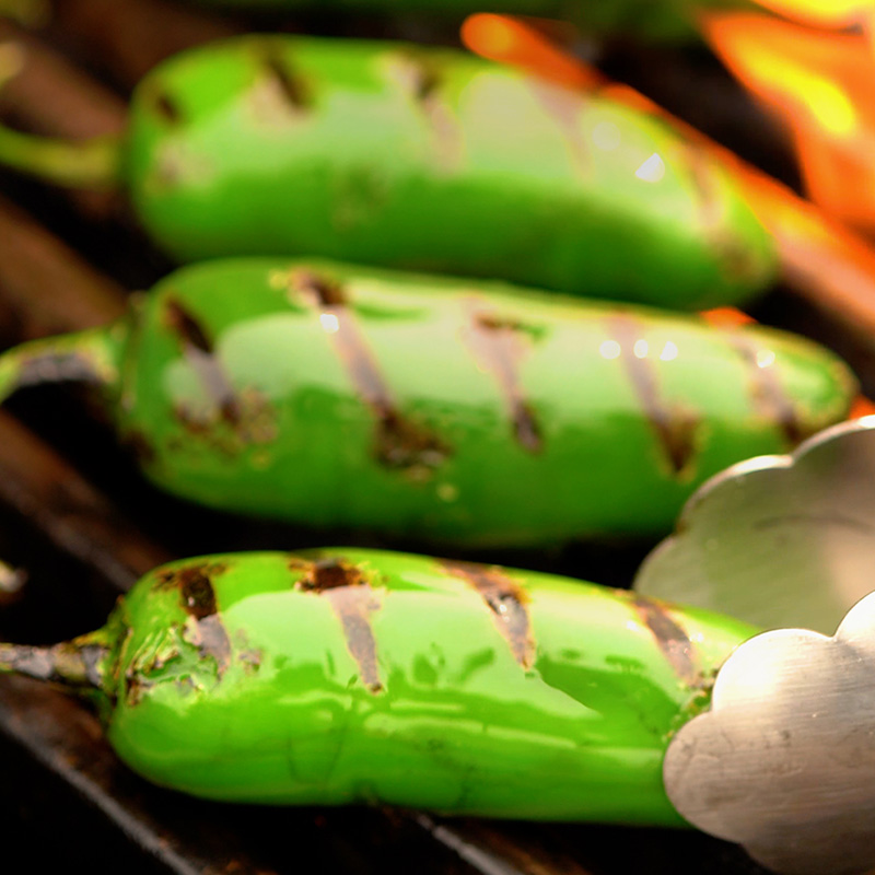 3 jalepenos on a grill