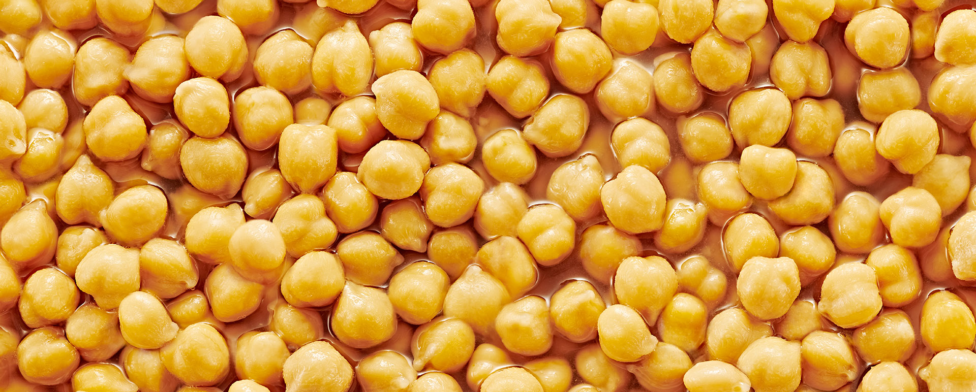 A close-up of red and light kidney beans being cooked