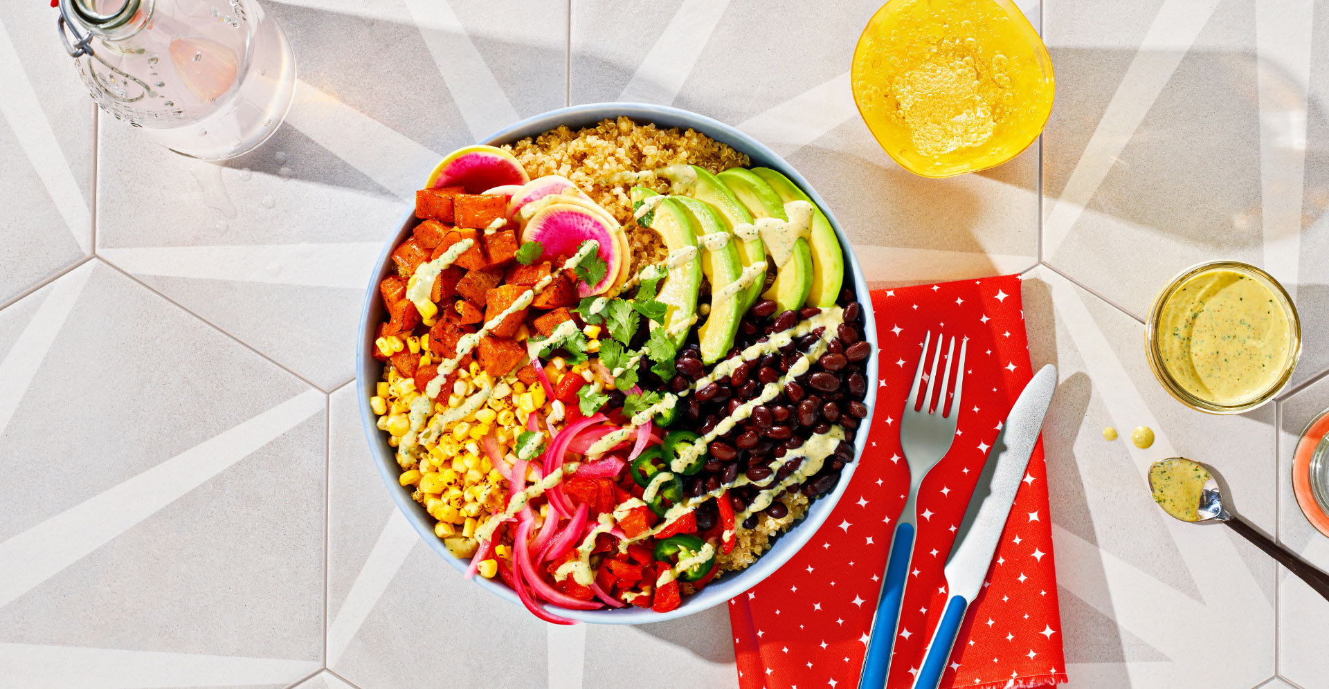 Grain Bowl topped with veggies and homemade creamy dressing drizzle