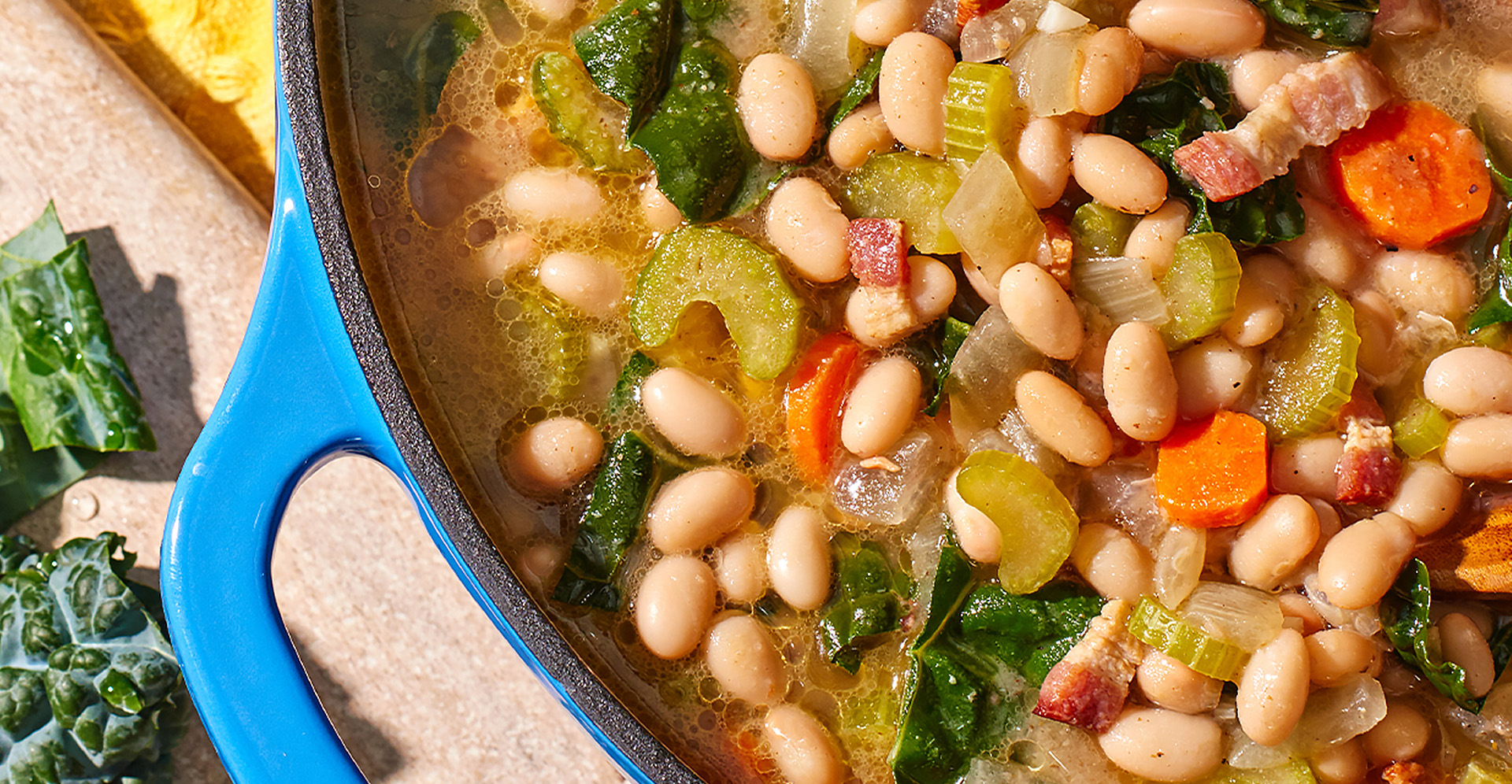 Close-up up of Navy Bean soup in a blue Dutch oven