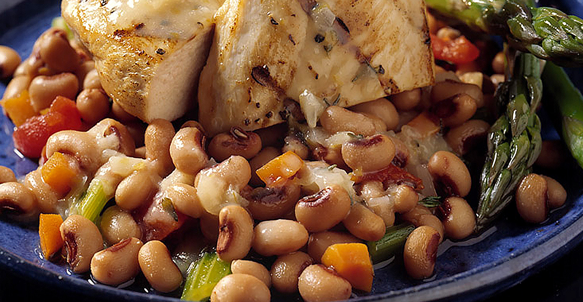 Grilled chicken breast served on a bed of blackeye peas and Navy beans