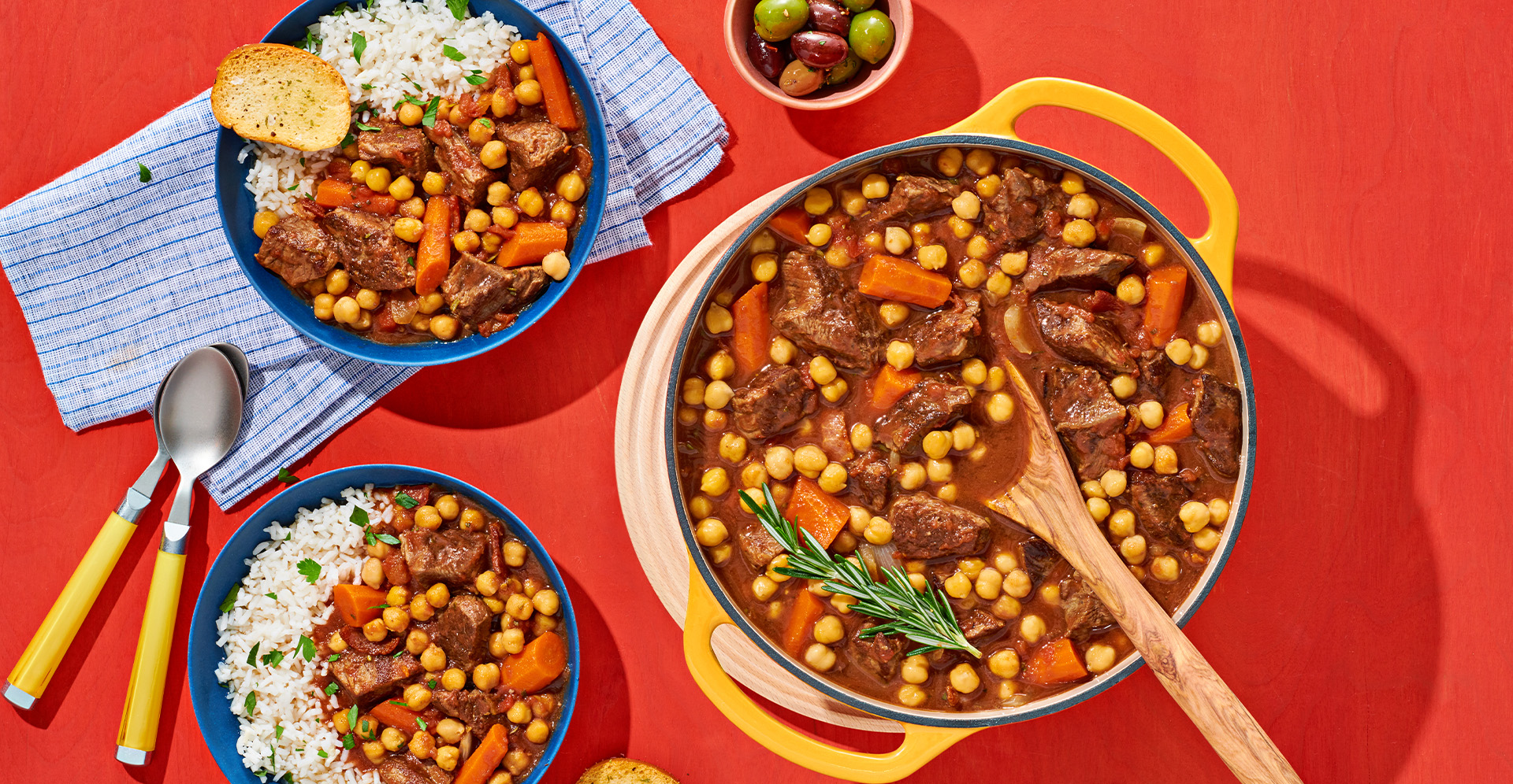 Mediterranean beef and bean stew in a large Dutch oven and in two bowls served with white rice