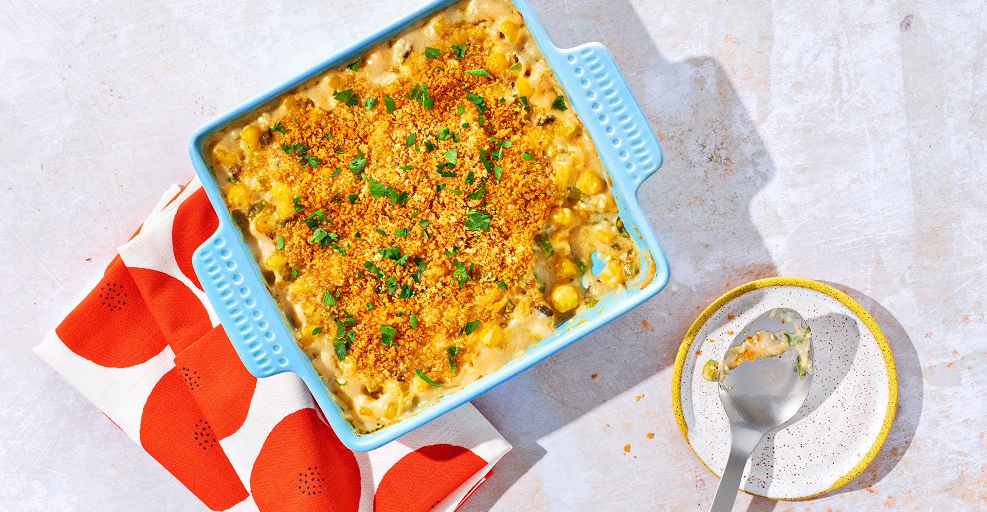 Golden Hominy Casserole with veggies. Topped with parsley and parmesan cheese