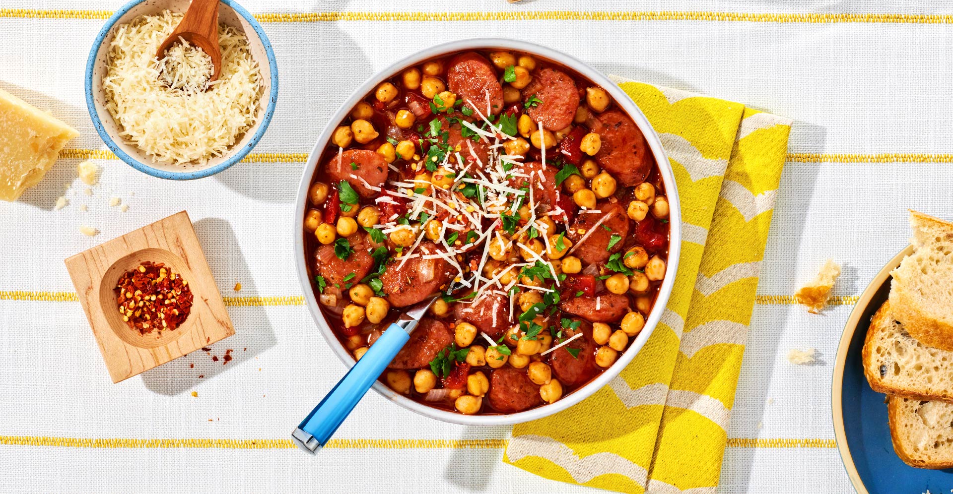 Italian sausage in garbanzo beans topped with parmesan cheese and chopped parsley
