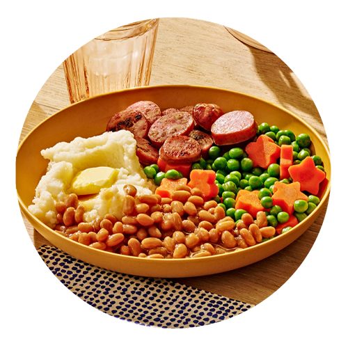 Plate with baked beans, mashed potatoes, sausages, and peas and carrots.